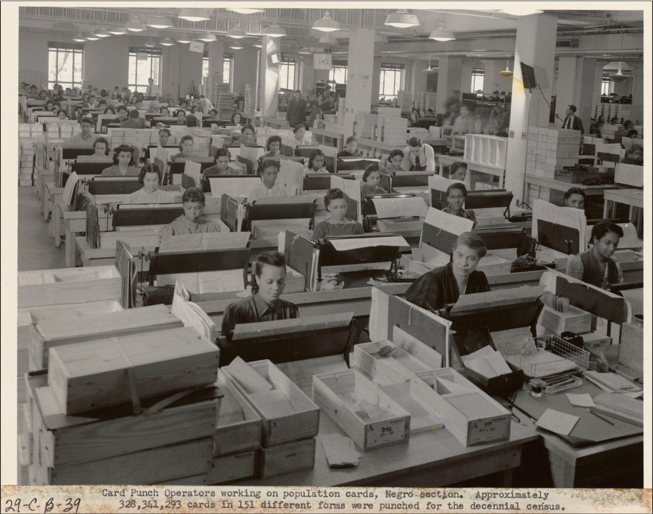 A vast room of card-punch operators keying population data onto cards for the census