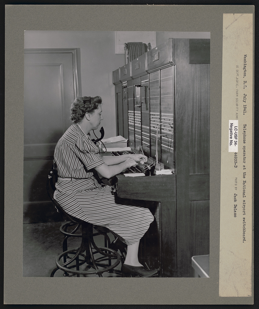 A telephone switchboard operator connecting calls at the National Airport switchboard