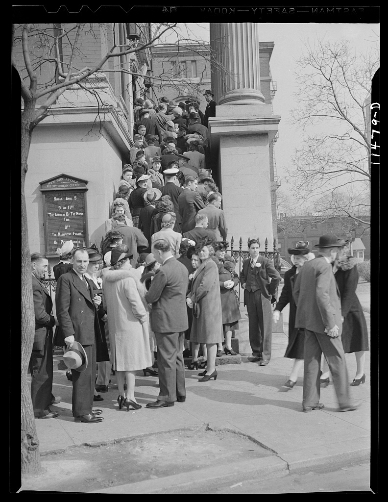 A long queue of people waiting outside a building in Washington, D.C.