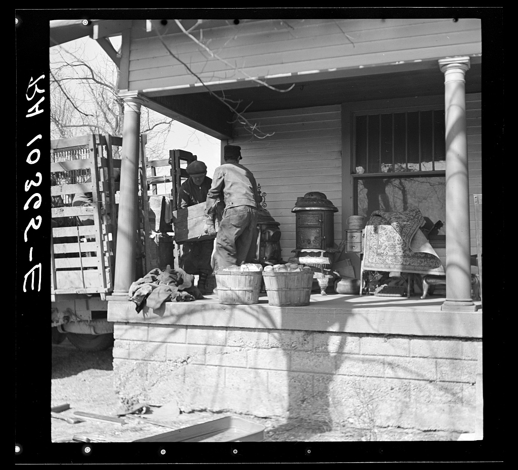 Workers removing furniture from a truck during a tenant farmer's move near Shadeland, Indiana
