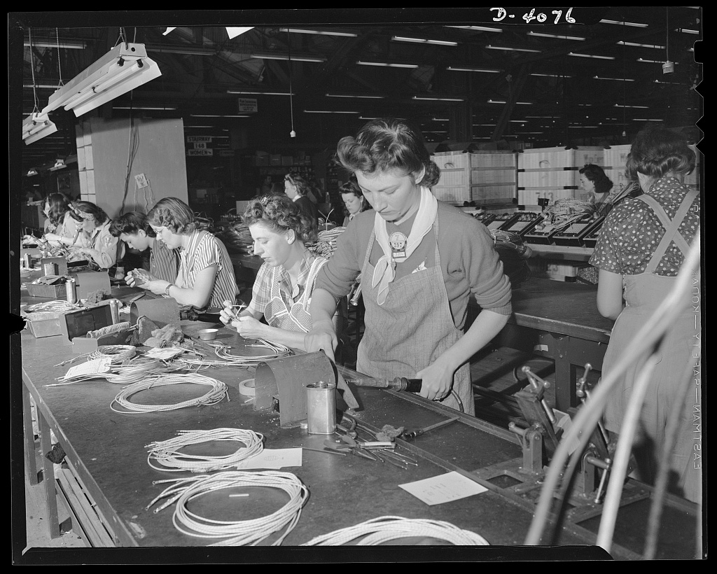 Women workers on the assembly line producing electrical sub-assemblies at a wartime factory