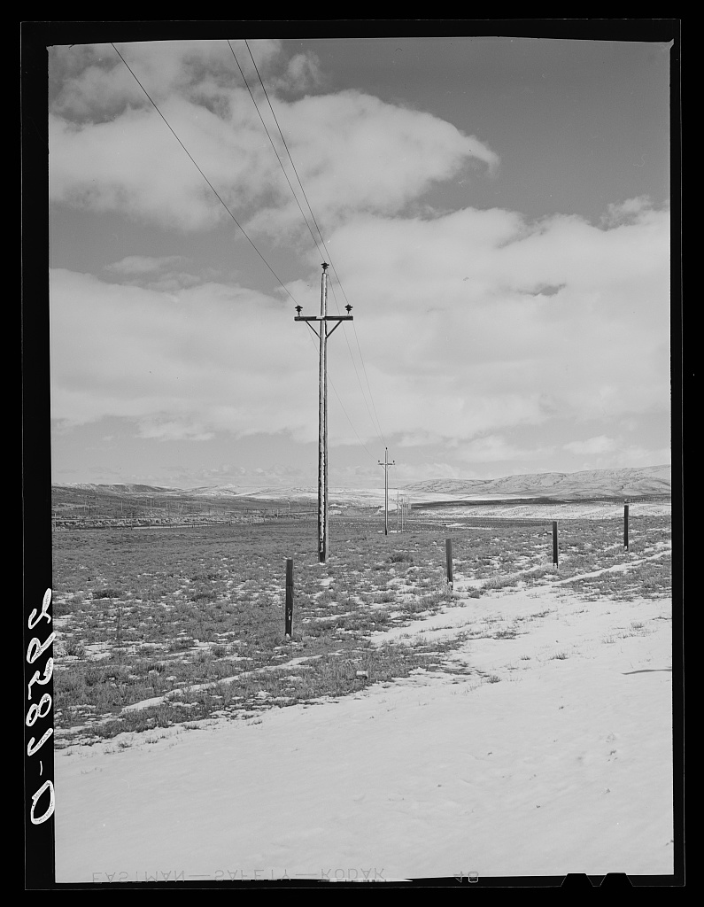 An electrical power line stretching across the Wyoming landscape
